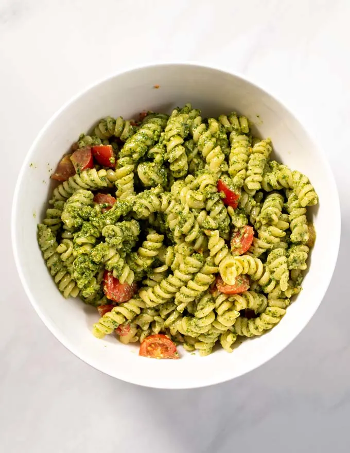 Top view of a mixing bowl with the mixed Pesto Salad.