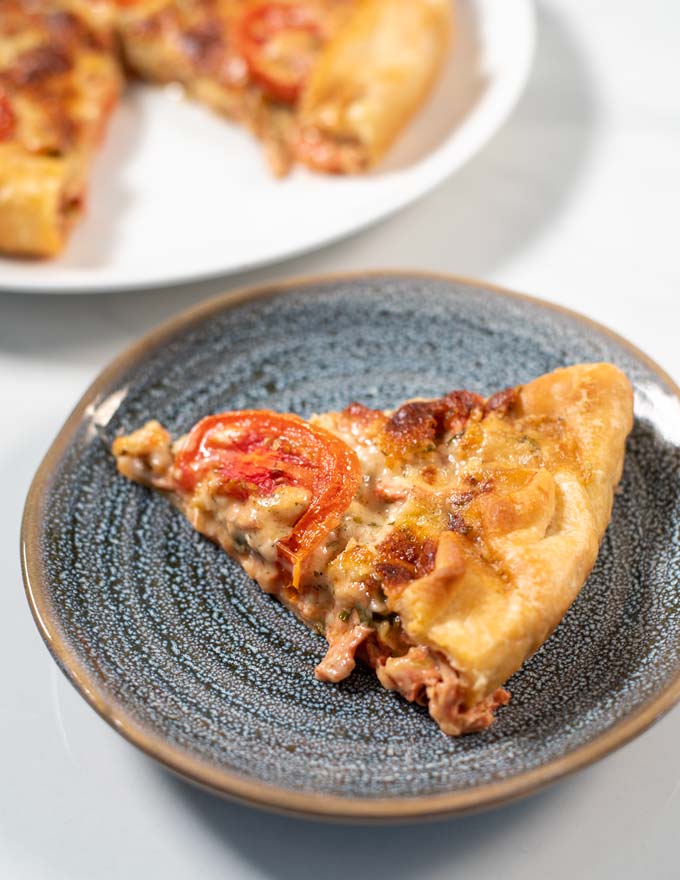 Closeup on a slice of Tomato Pie on a plate.