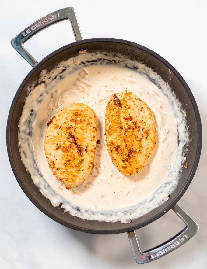 Cooked Cajun Chicken filets are given into the sauce.