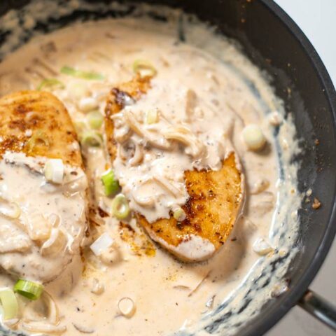 Closeup view on a serving of Cajun Chicken in a pan.