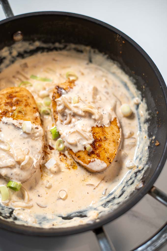 Closeup view on a serving of Cajun Chicken in a pan.