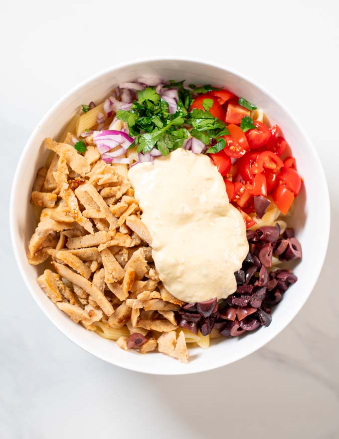 All ingredients for the Chicken Pasta Salad are given into a large bowl.