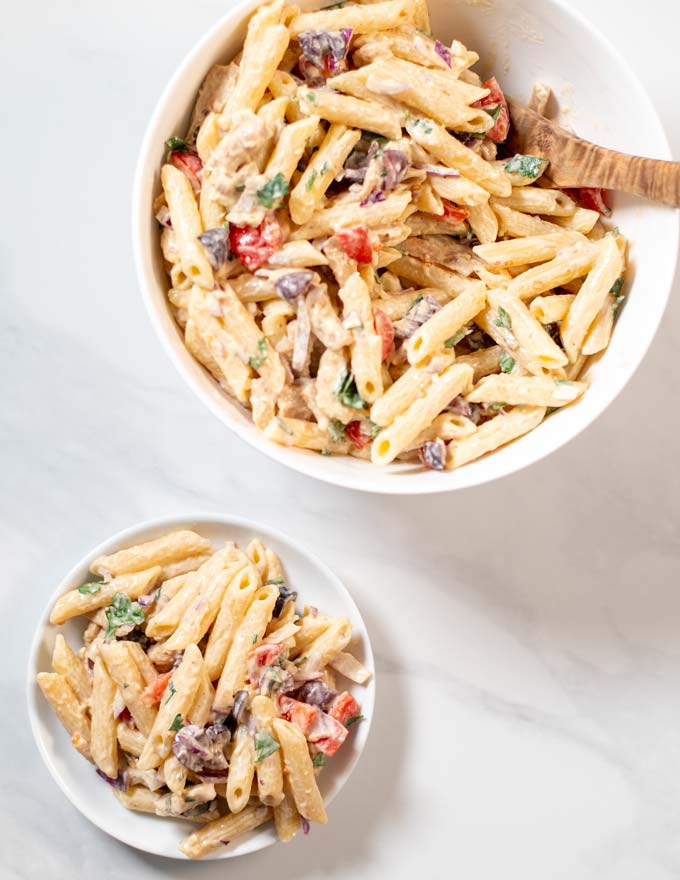 Top view of a serving of Chicken Pasta Salad with a serving bowl in the background.