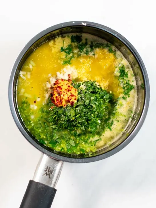 Sauce pan with melted butter and all ingredients for the Cowboy Butter.