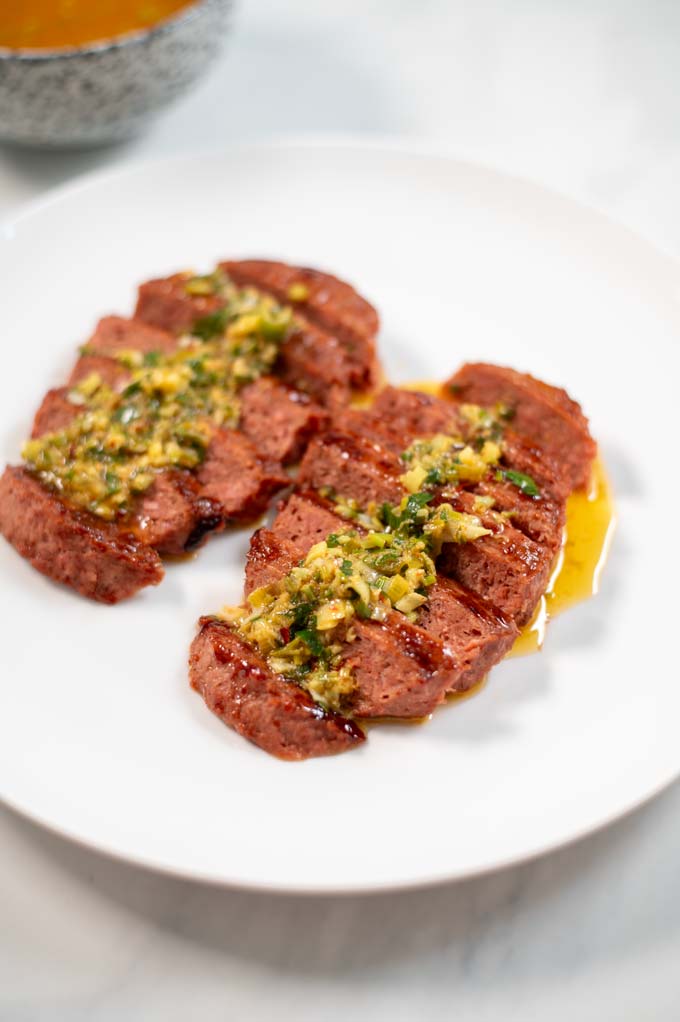 Closeup to a small portion of sliced burger steaks with Cowboy Butter.