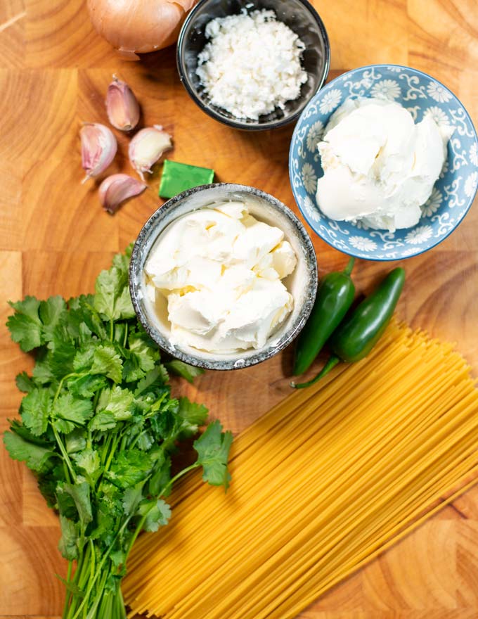 Ingredients needed for making Green Spaghetti are collected on a board.