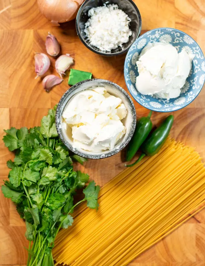 Ingredients needed for making Green Spaghetti are collected on a board.