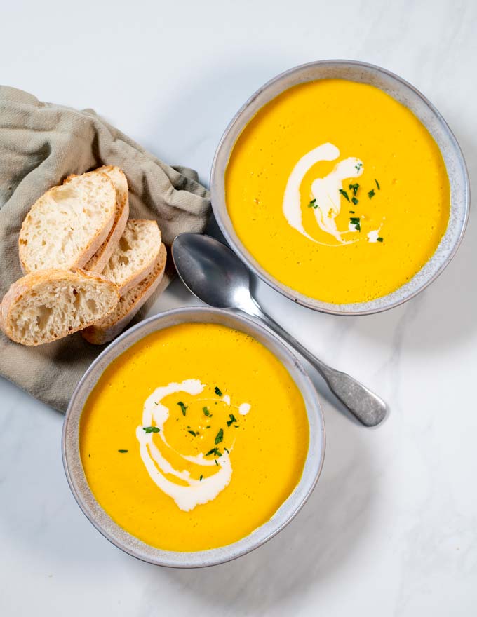 Pumpkin Soup is served on two plates.
