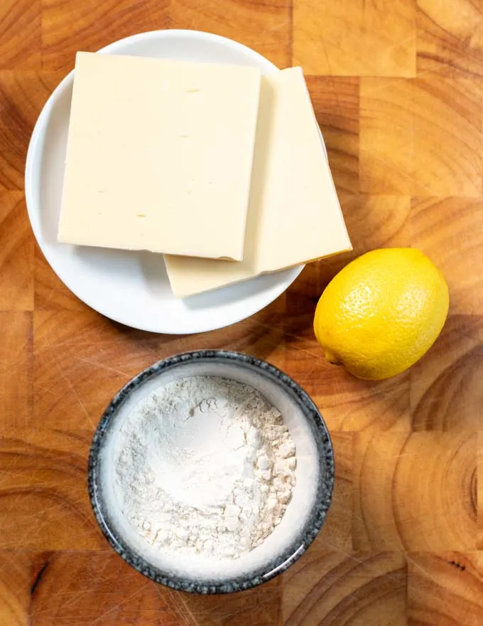 Ingredients needed for making Saganaki on a board.