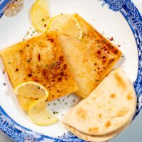 Serving of Saganaki with pita bread.