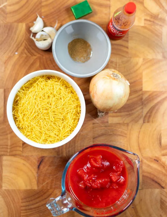 Ingredients needed for making Sopa de Fideo on a board.