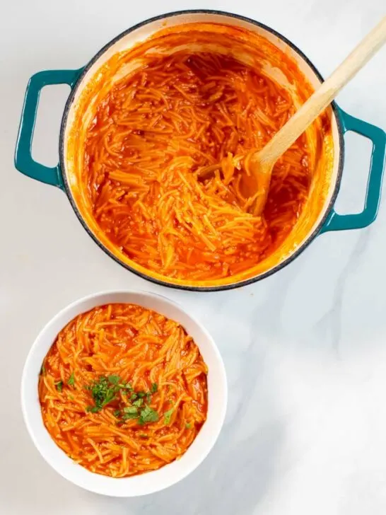 A portion of Sopa de Fideo is served in a small white bowl.