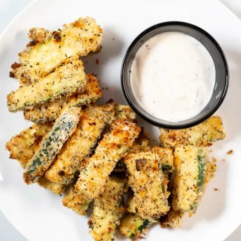 Top view on a serving of Zucchini Fries with a dip.