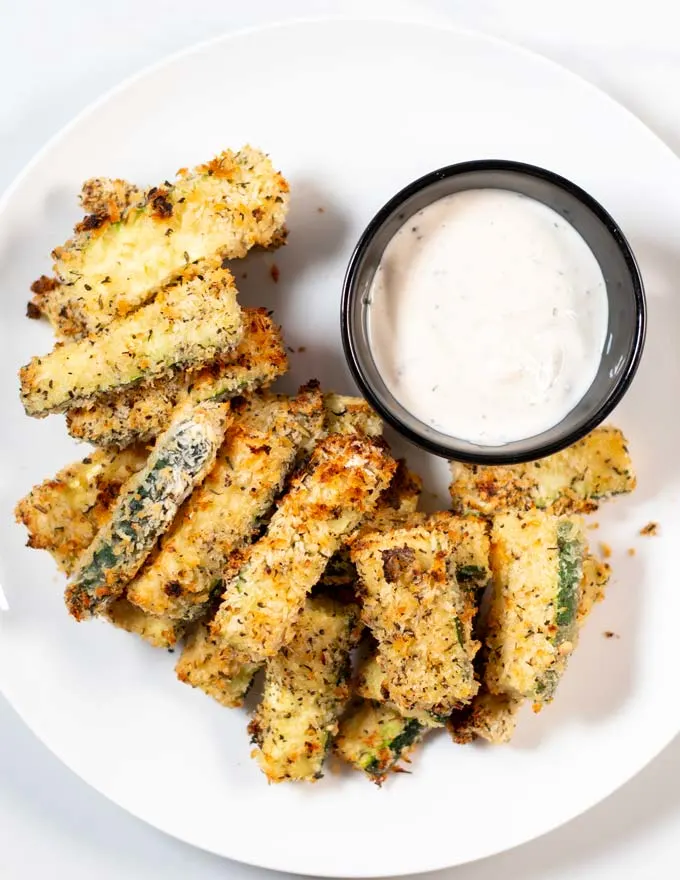 Top view on a serving of Zucchini Fries with a dip.