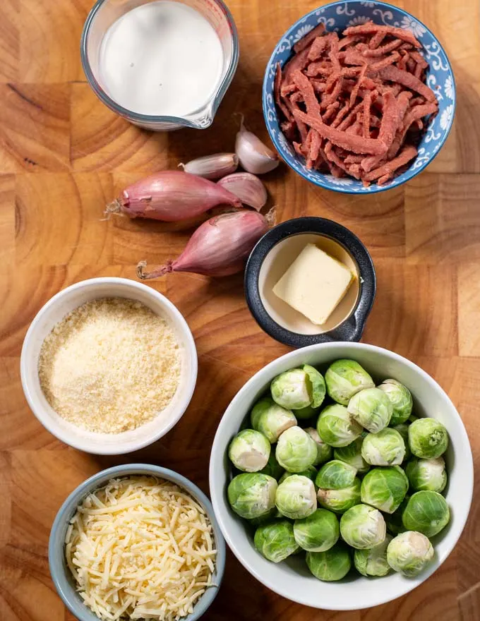 Ingredients needed for making Brussels Sprouts Bake are collected on a board.