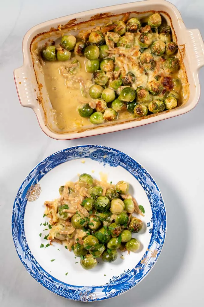 Top view on a serving of Brussels Sprouts Bake with casserole dish in the background.