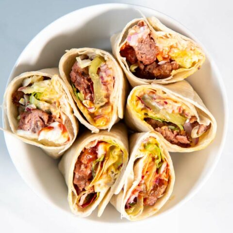 Top view of a bowl with cut open Burger Wraps.