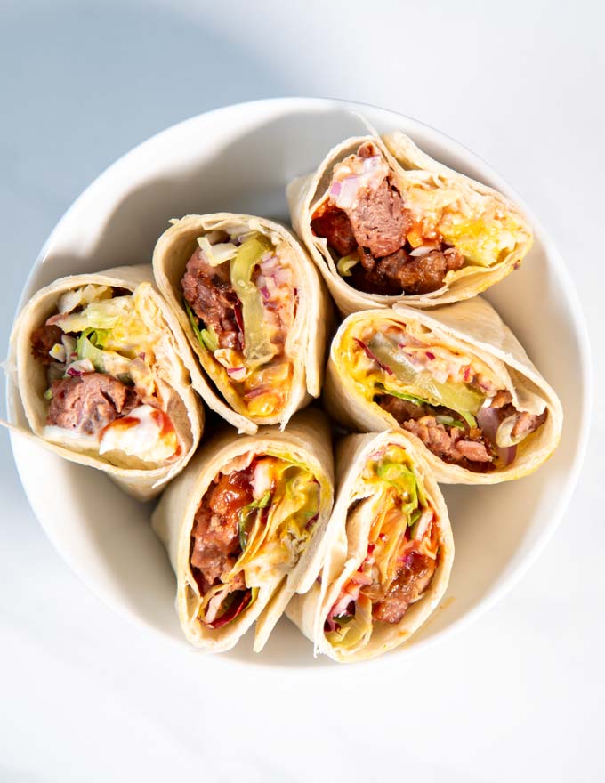 Top view of a bowl with cut open Burger Wraps.