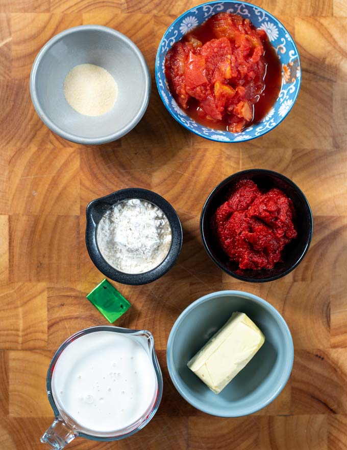 Ingredients needed to make Tomato Gravy are collected on a board.