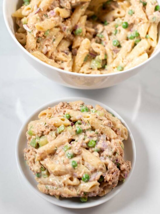 Serving of Tuna Pasta Salad with serving bowl in the background.