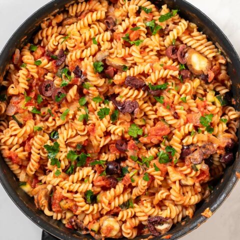 Top view of a pan with Veggie Pasta, garnished with parsley.