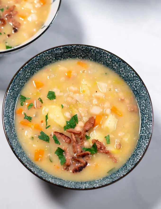 View on a portion of white bean soup in a bowl.