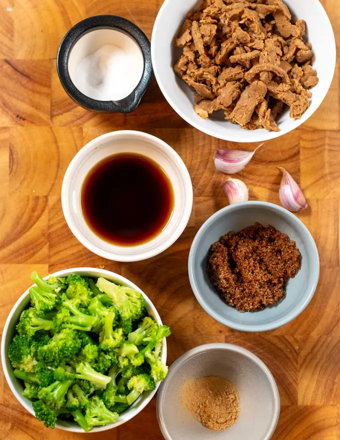 Ingredients needed to make this Beef Broccoli Recipe Hawaii are collected on a wooden board.