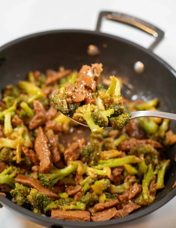 Closeup on a spoon full of Beef Broccoli.