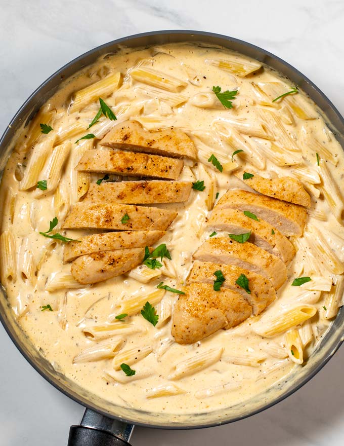 Two Cajun Chicken filets served on creamy Cajun Alfredo Pasta.