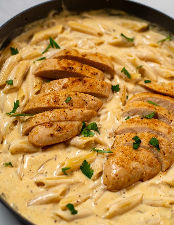 Juicy vegan chicken filets on top of Cajun Alfredo Pasta.