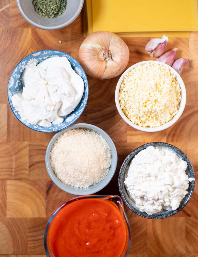 Ingredients needed to make Cheese Lasagna are collected on a board.