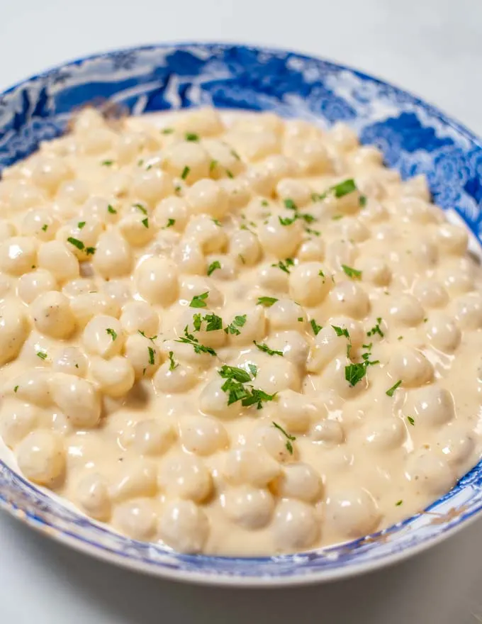 Closeup on the Creamed Onions in a bowl.