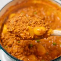 A large spoon of Hawaiian Hamburger Curry is lifted from the large saucepan.