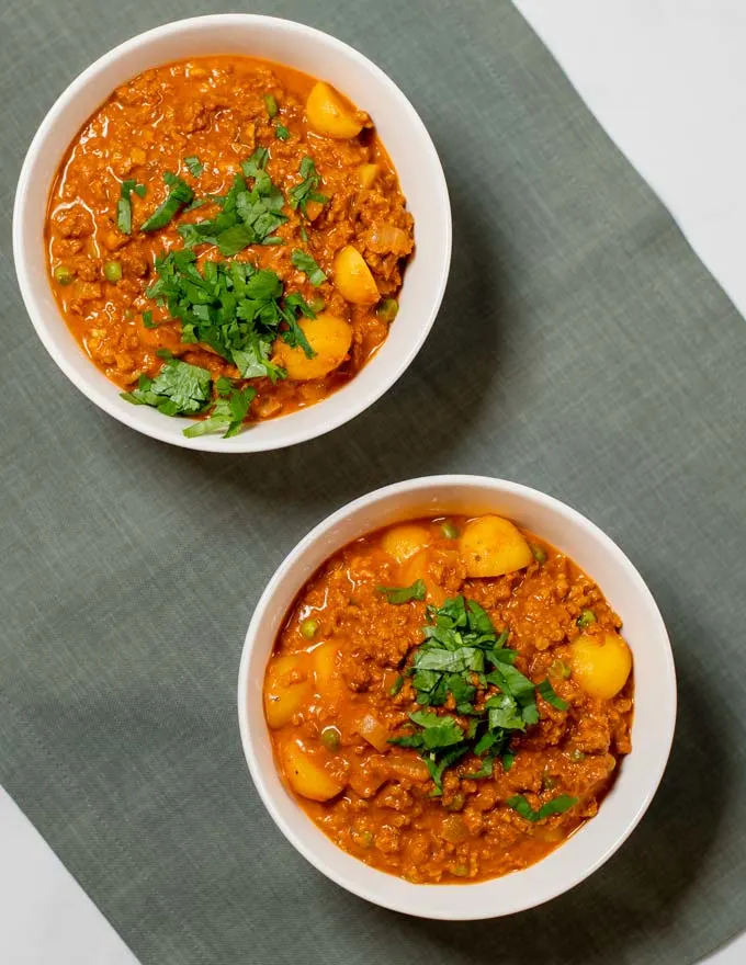 Two servings of Hamburger Curry in white bowls.