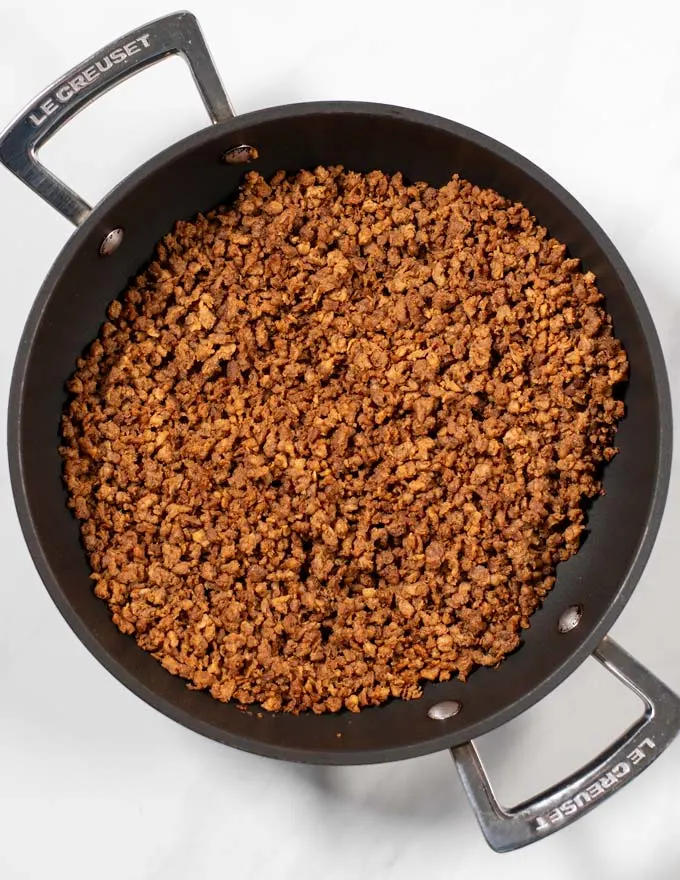 Step by step instruction showing how vegan ground beef is fried in a pan.