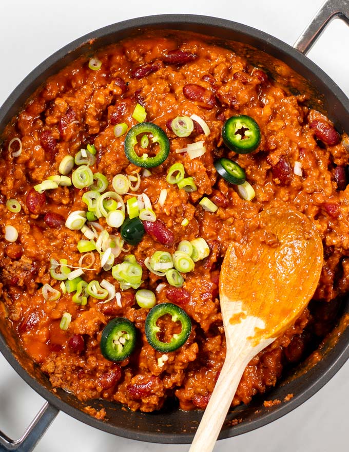 Texas Chili Beans are garnished with green onions an jalapeños.