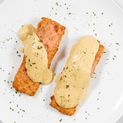 Serving of two pieces of vegan salmon with Dijon Mustard Sauce.