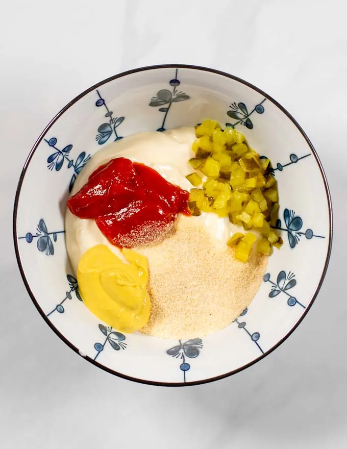 Top view of a small mixing bowl with the ingredients of the Keto Big Mac Sauce.