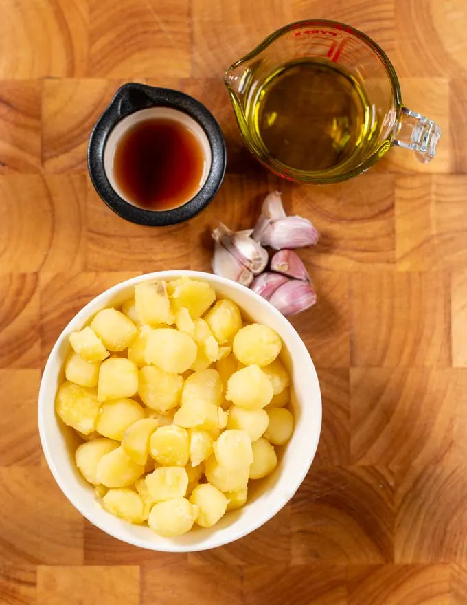 Ingredients needed to make Skordalia collected on a board.