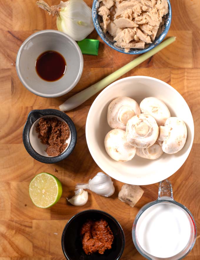 Ingredients needed to make Tom Kha Soup are collected on a board.