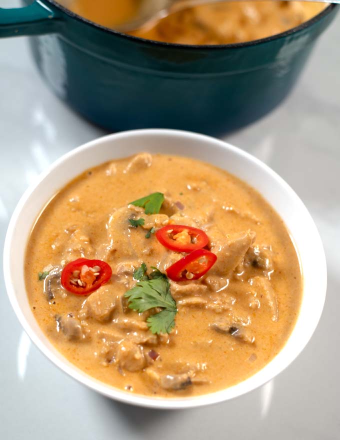 Closeup of a serving bowl with Vegetarian Tom Kha Soup.
