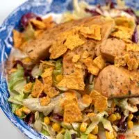 Closeup on Chicken Tenders Salad on a large serving plate.