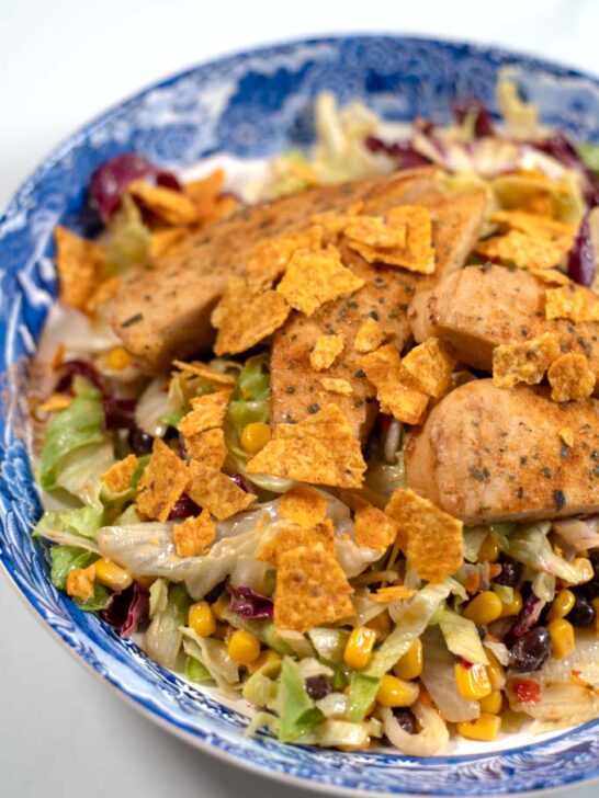 Closeup on Chicken Tenders Salad on a large serving plate.