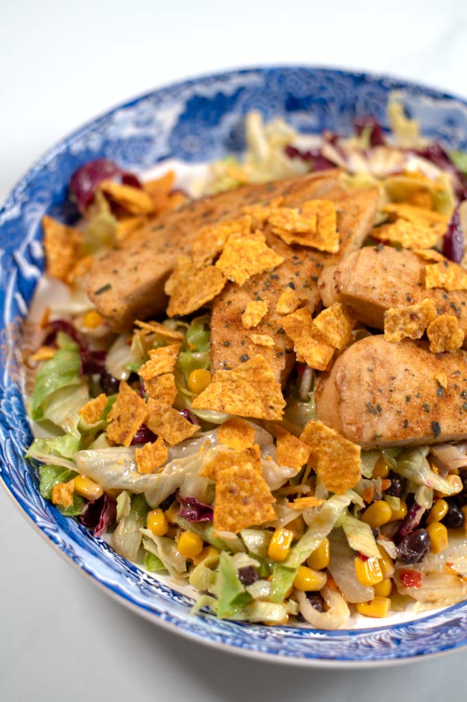 Closeup on Chicken Tenders Salad on a large serving plate.
