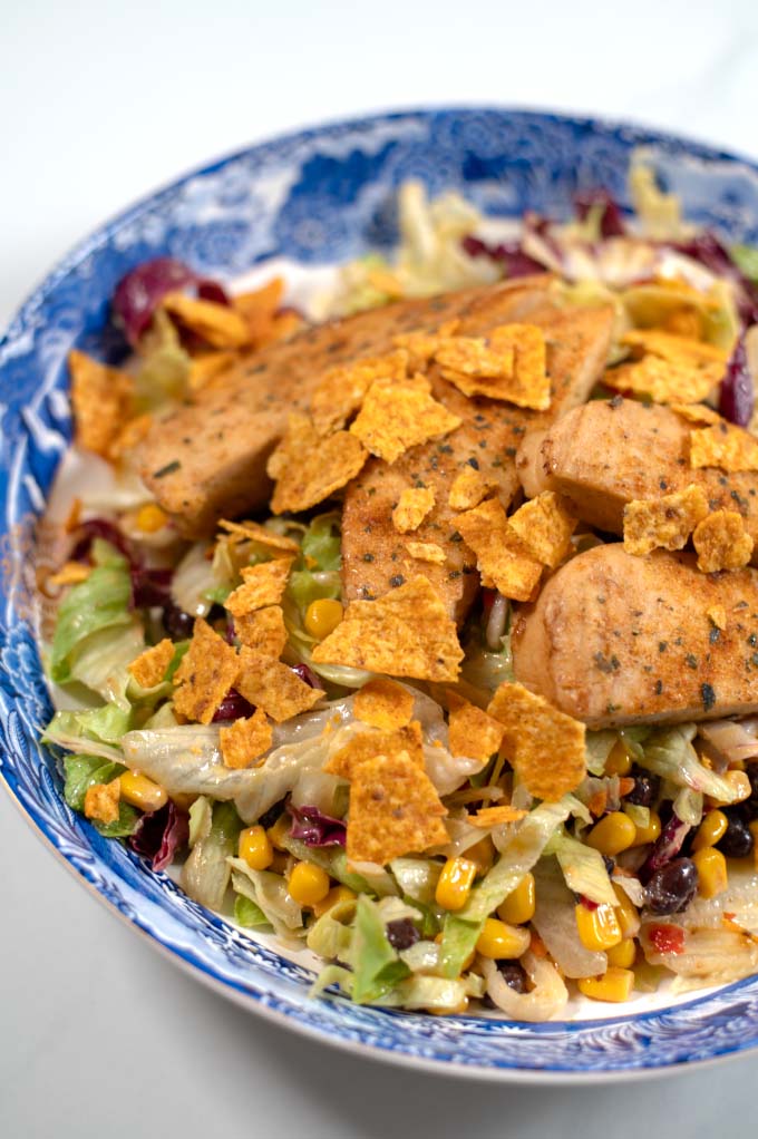 Closeup on Chicken Tenders Salad on a large serving plate.