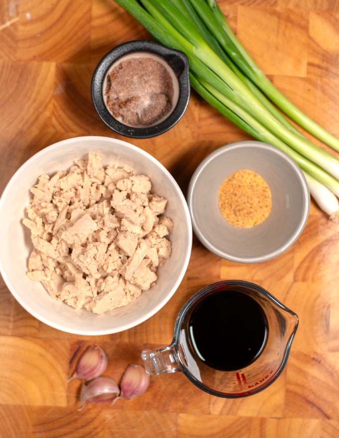 Ingredients needed to make Cajun Sticky Chicken are collected on a board.