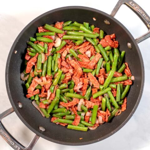 Top view of a large pan with Green Beans with Bacon.