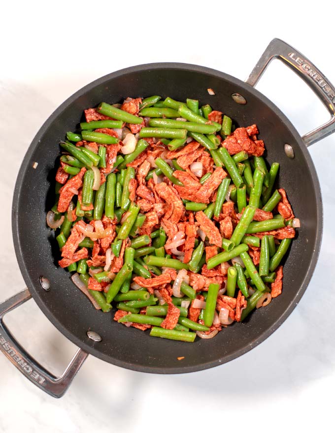 Top view of a large pan with Green Beans with Bacon.