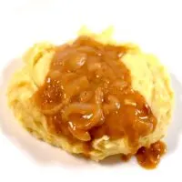 A good serving of creamy Southern Onion Gravy with mashed potatoes.