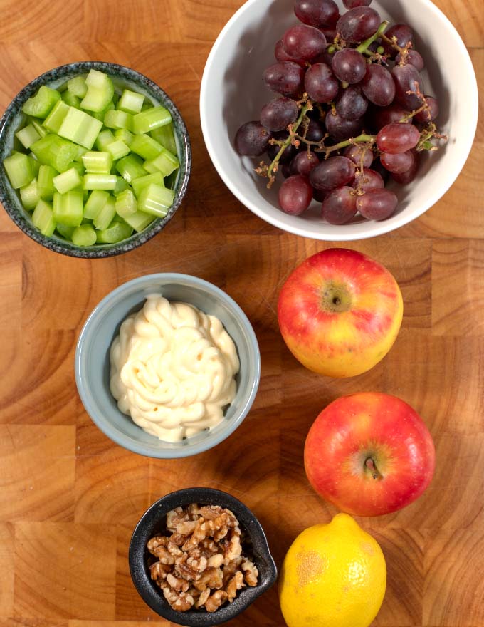Ingredients needed to make Waldorf Salad with Grapes, collected on a board.